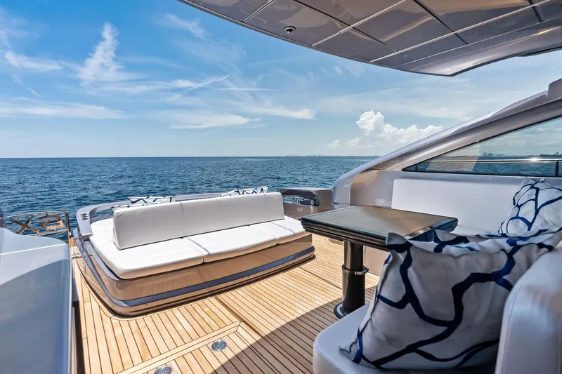  Yacht Photos Pics Luxurious 2024 Pershing 6X yacht deck with elegant seating and ocean view.