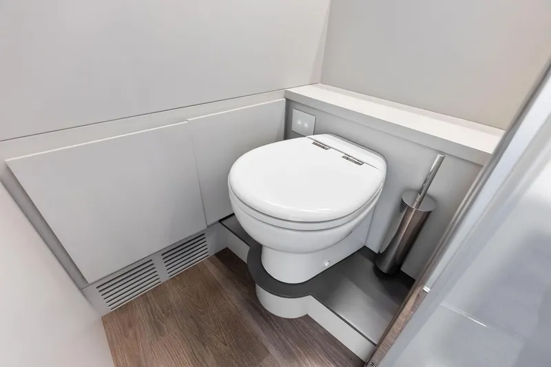  Yacht Photos Pics Modern bathroom in 2024 Pershing 6X yacht with sleek design and wooden flooring.