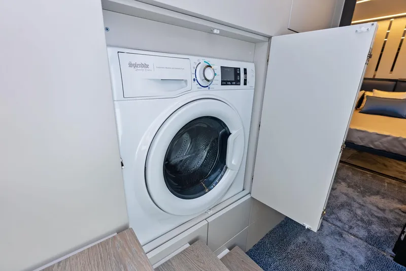  Yacht Photos Pics Built-in washing machine on Pershing 6X yacht, 2024 model, with open cabinet door.