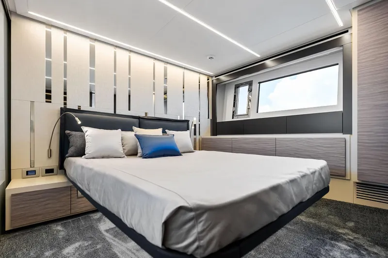  Yacht Photos Pics Luxurious bedroom interior of 2024 Pershing 6X yacht with modern design and elegant furnishings.