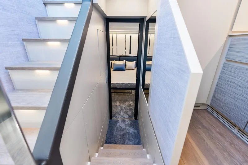  Yacht Photos Pics Staircase leading to a luxurious bedroom in a 2024 Pershing 6X yacht.