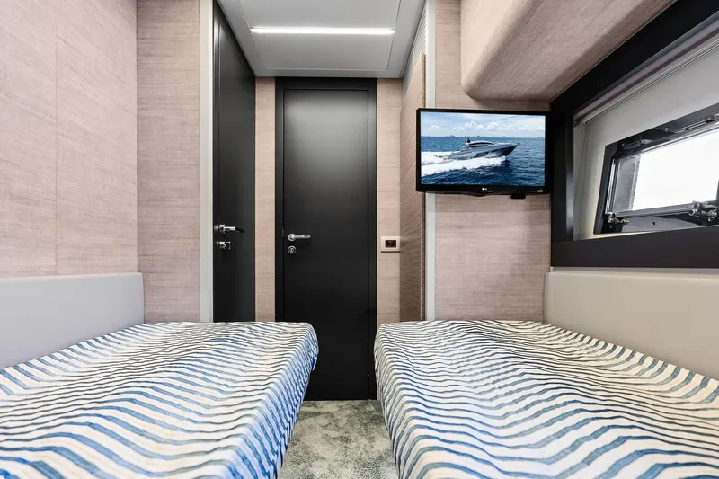  Yacht Photos Pics 2024 Pershing 6X yacht cabin with twin beds and wall-mounted TV.