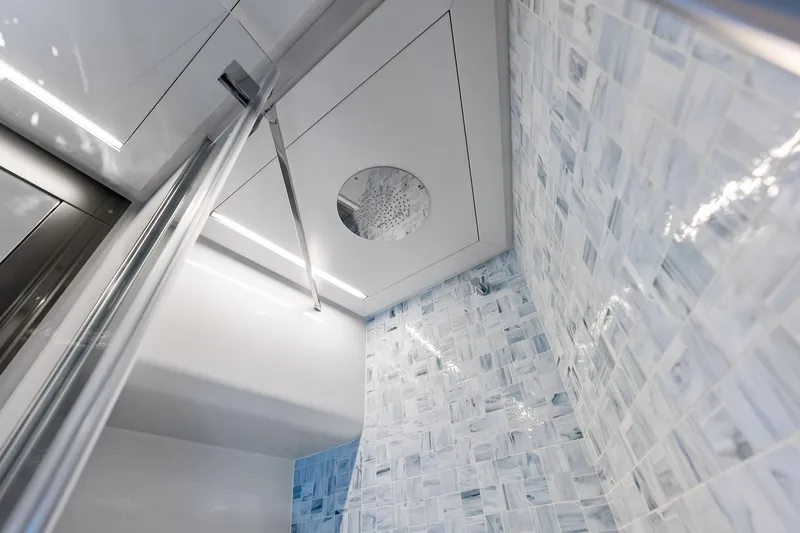  Yacht Photos Pics Luxurious bathroom interior of 2024 Pershing 6X yacht with modern tile design.