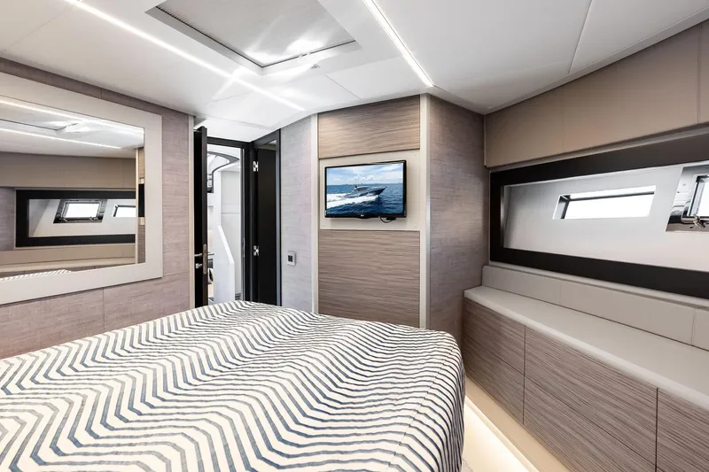  Yacht Photos Pics Luxurious 2024 Pershing 6X yacht bedroom with modern decor and sleek design.