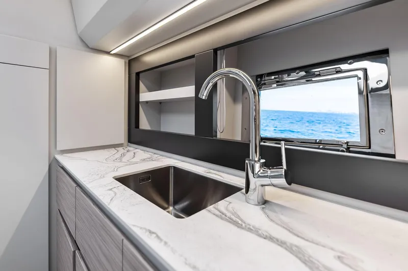  Yacht Photos Pics Modern kitchen interior of 2024 Pershing 6X yacht with sleek sink and ocean view.
