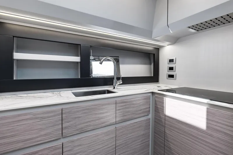  Yacht Photos Pics Modern kitchen interior of 2024 Pershing 6X yacht with sleek design and marble countertops.