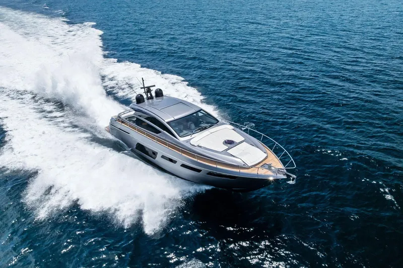  Yacht Photos Pics 2024 Pershing 6X yacht cruising swiftly on open blue sea.