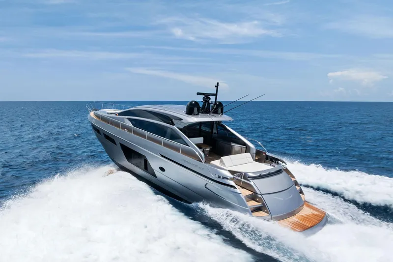  Yacht Photos Pics 2024 Pershing 6X yacht cruising on open sea under clear blue sky.