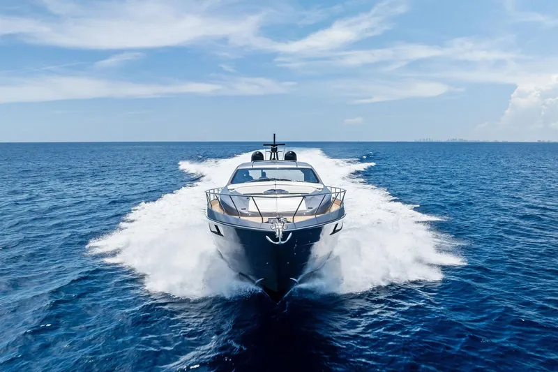  Yacht Photos Pics 2024 Pershing 6X yacht cruising on open sea under clear blue sky.