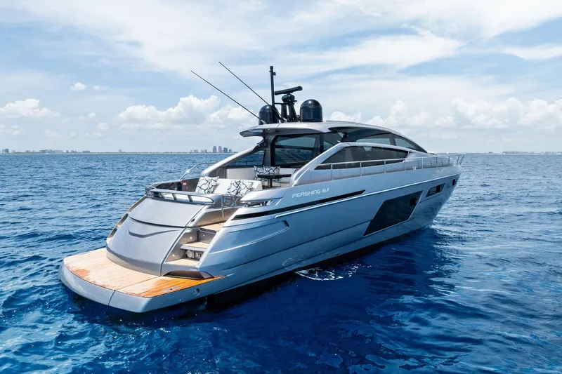  Yacht Photos Pics 2024 Pershing 6X luxury yacht cruising on open blue sea under clear sky.