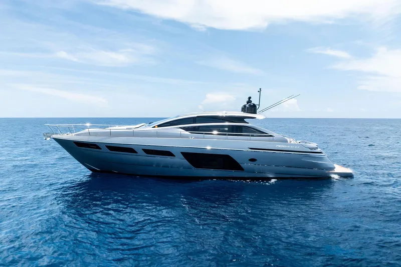  Yacht Photos Pics 2024 Pershing 6X yacht cruising on open sea under clear blue sky.