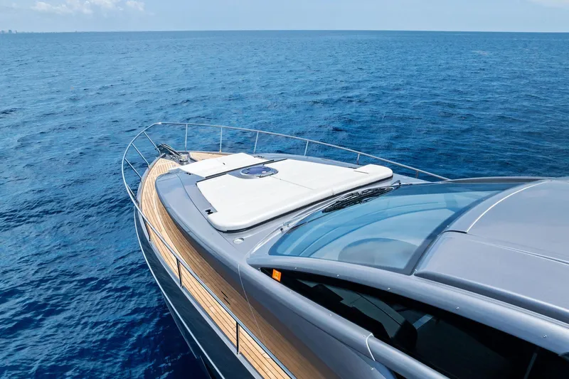  Yacht Photos Pics 2024 Pershing 6X yacht cruising on open blue sea, showcasing sleek design.
