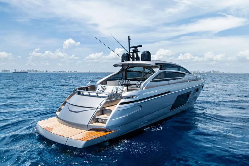 Yacht Photos Pics 2024 Pershing 6X yacht cruising on open sea under clear blue sky.