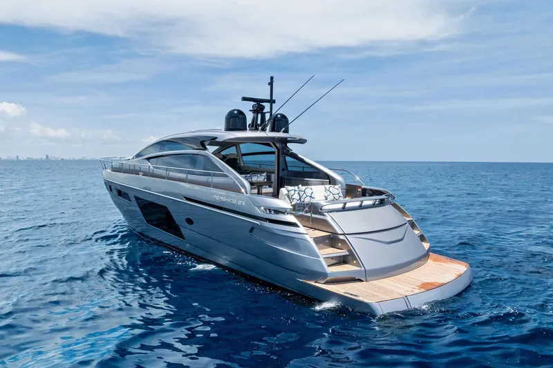  Yacht Photos Pics 2024 Pershing 6X luxury yacht cruising on open sea under clear skies.