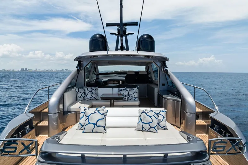  Yacht Photos Pics 2024 Pershing 6X luxury yacht on open sea, featuring elegant seating and modern design.