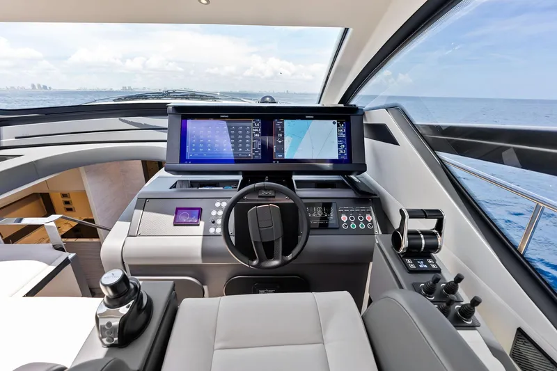  Yacht Photos Pics 2024 Pershing 6X yacht cockpit with advanced navigation displays and controls, overlooking the ocean.