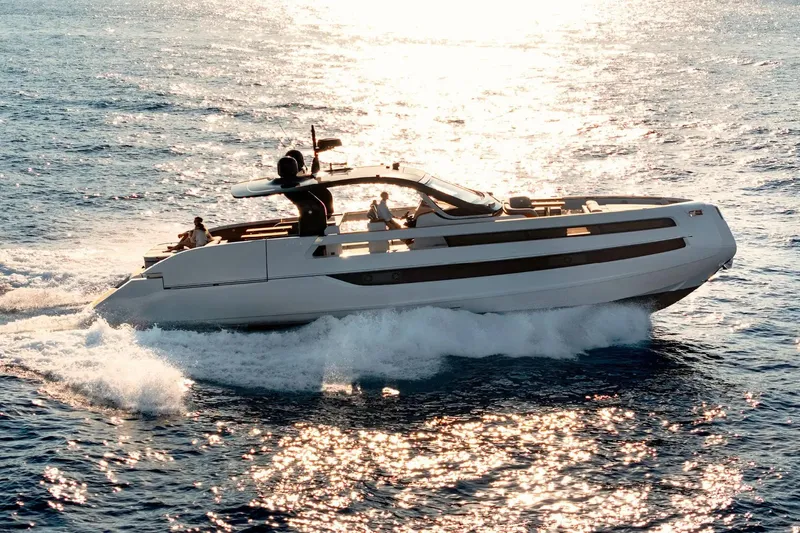  Yacht Photos Pics 2025 Invictus TT550 yacht cruising on sunlit ocean waters.