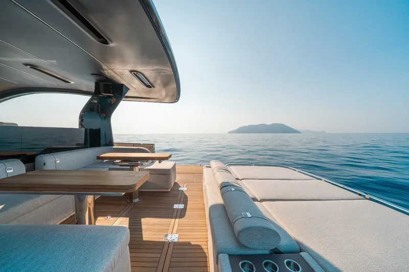  Yacht Photos Pics Luxurious 2025 Invictus TT550 yacht interior with ocean view and island in the distance.