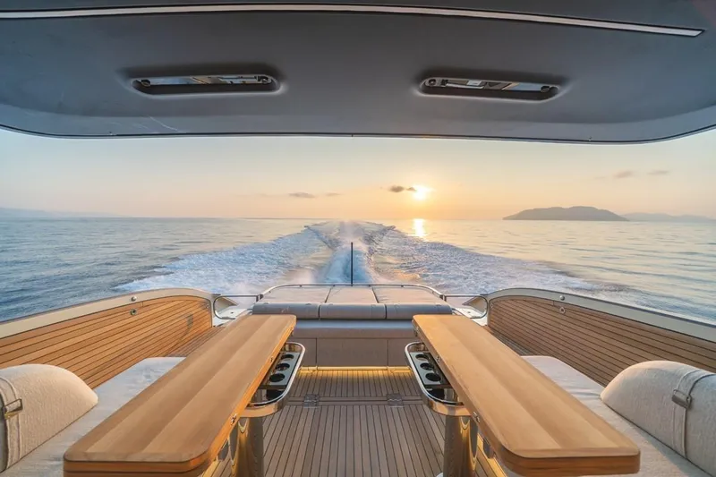  Yacht Photos Pics Luxurious 2025 Invictus TT550 yacht interior with sunset ocean view.