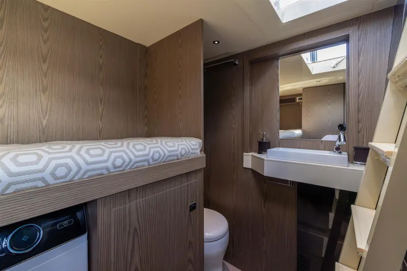  Yacht Photos Pics Luxurious bathroom interior of 2025 Invictus TT550 yacht with modern fixtures and wood finish.