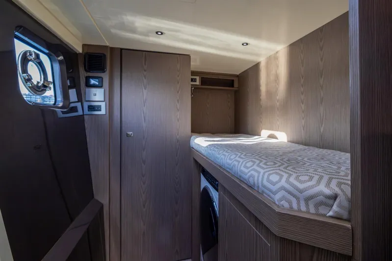  Yacht Photos Pics Luxurious interior cabin of 2025 Invictus TT550 yacht with modern wood finish.