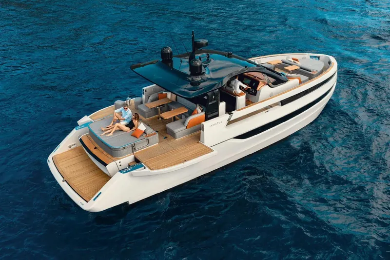  Yacht Photos Pics Luxury Invictus TT550 yacht cruising on blue ocean waters, 2025 model.