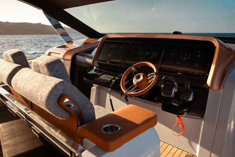  Yacht Photos Pics Luxurious helm of 2025 Invictus TT550 yacht with modern controls and plush seating.