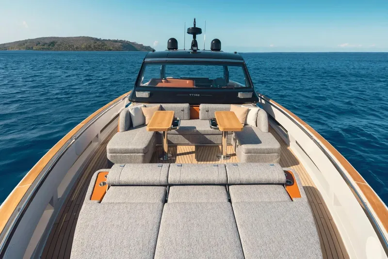  Yacht Photos Pics Luxurious 2025 Invictus TT550 yacht with elegant seating, cruising on serene blue waters.