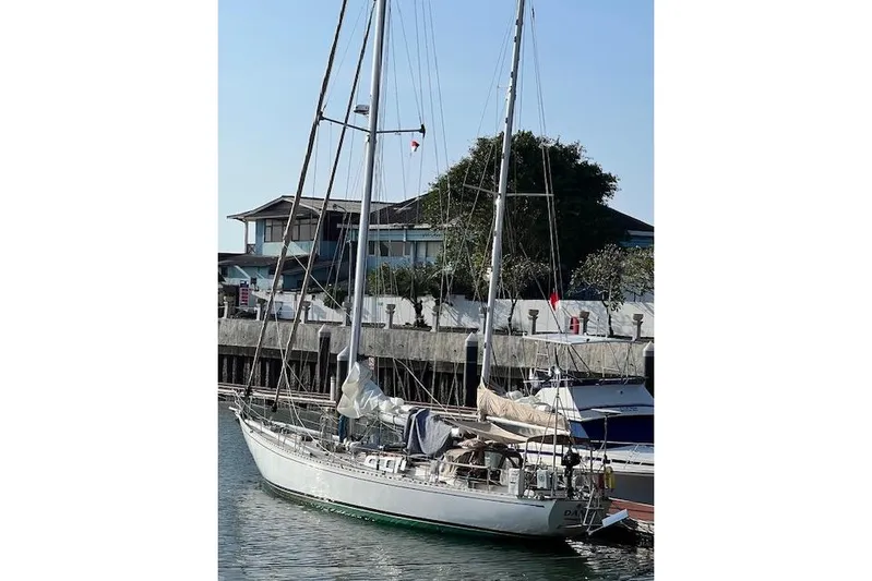  Yacht Photos Pics 1985 Robert Clark Ketch sailboat docked at marina, clear sky background.