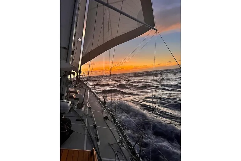  Yacht Photos Pics Sailing at sunset on a 1985 Robert Clark Ketch, ocean waves in view.
