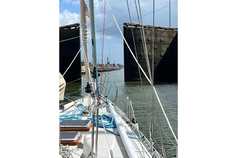  Yacht Photos Pics Sailing through canal lock on 1985 Robert Clark Ketch, blue skies above.