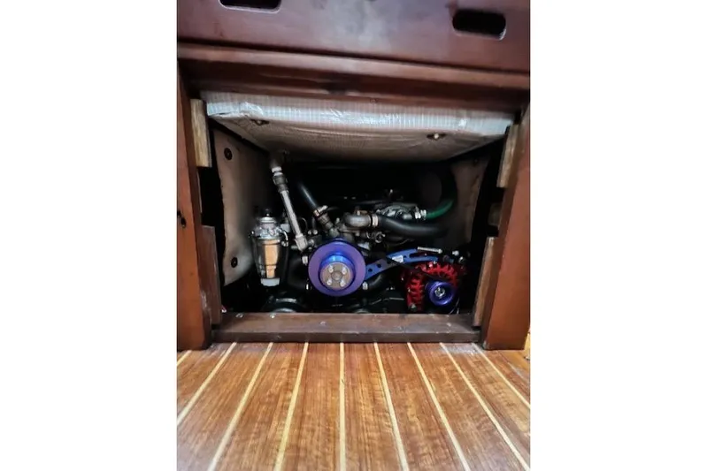  Yacht Photos Pics Engine compartment of a 1985 Robert Clark Ketch sailboat, featuring visible mechanical components.