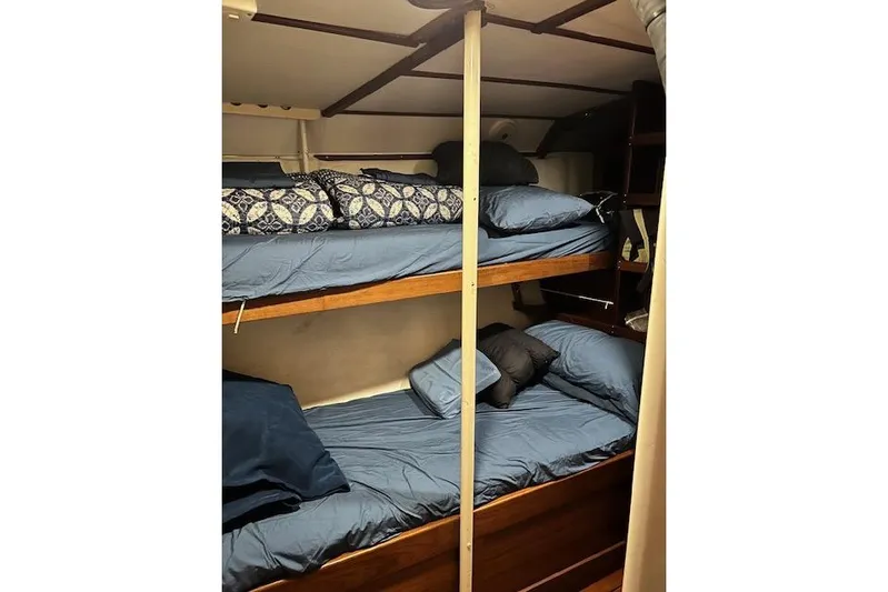  Yacht Photos Pics Bunk beds in 1985 Robert Clark Ketch sailboat cabin with blue bedding.