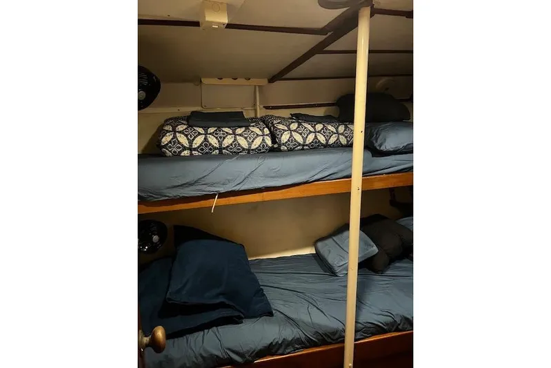  Yacht Photos Pics Bunk beds in a 1985 Robert Clark Ketch sailboat cabin with blue bedding.