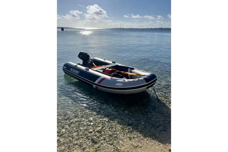  Yacht Photos Pics Inflatable boat on clear water, sunny day, Robert Clark Ketch 1985.