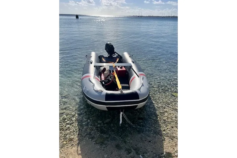  Yacht Photos Pics Inflatable boat on clear water, sunny day, Robert Clark Ketch 1985.