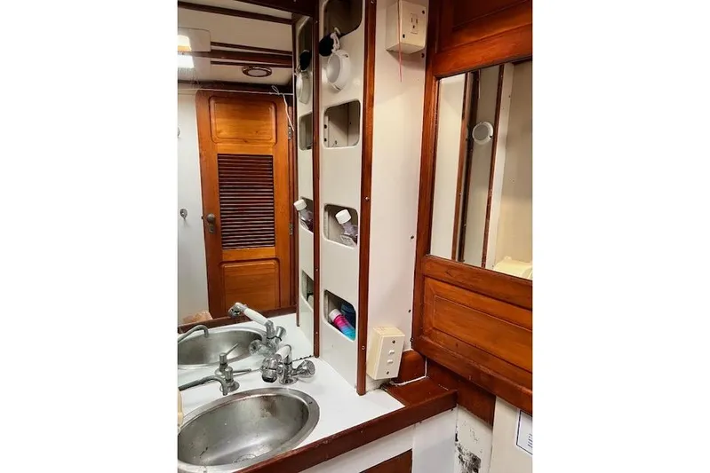  Yacht Photos Pics 1985 Robert Clark Ketch bathroom with wooden cabinetry and dual sinks.