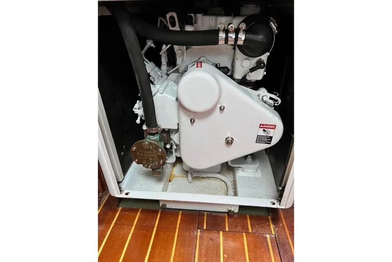  Yacht Photos Pics Engine compartment of 1985 Robert Clark Ketch with visible components and warning label.