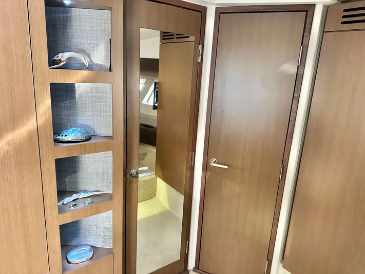  Yacht Photos Pics Interior of 2016 Sea Ray 400 Sundancer with wooden doors and shelves.