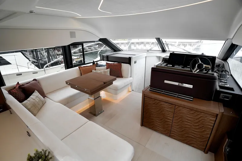  Yacht Photos Pics Luxurious interior of 2026 Prestige F4.9 yacht with elegant seating and modern helm.