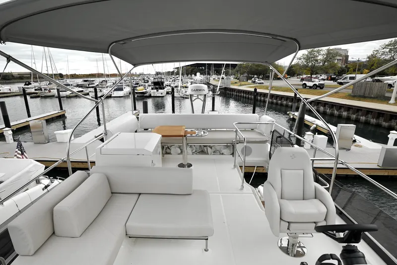  Yacht Photos Pics Luxurious 2026 Prestige F4.9 yacht interior at marina, featuring elegant seating and helm.