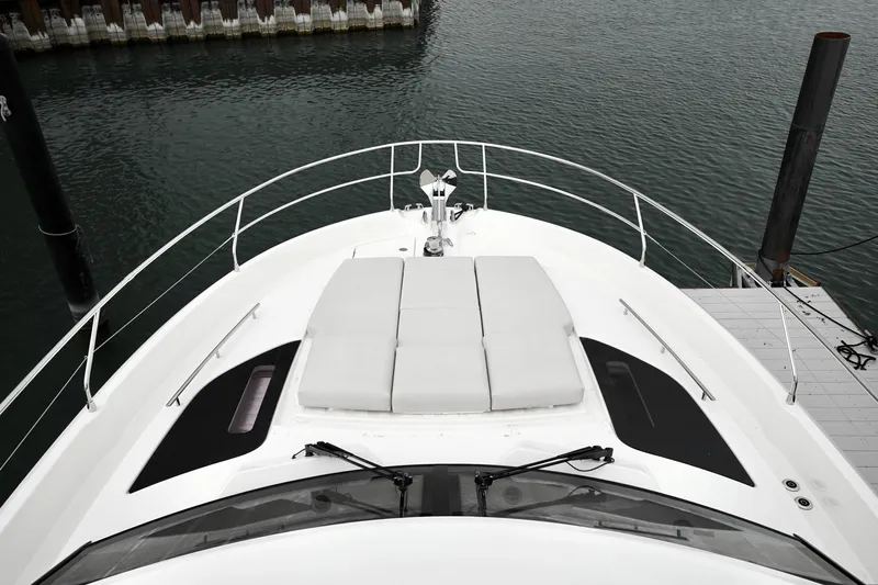  Yacht Photos Pics Prestige F4.9 yacht deck, 2026 model, docked at marina with sunbathing area.