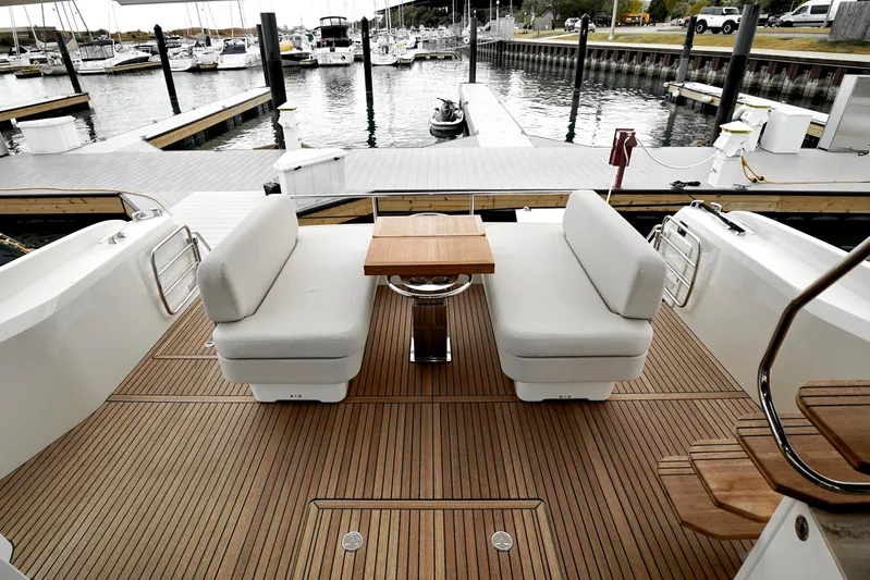  Yacht Photos Pics Luxurious Prestige F4.9 yacht deck with seating and table, docked at marina, 2026 model.