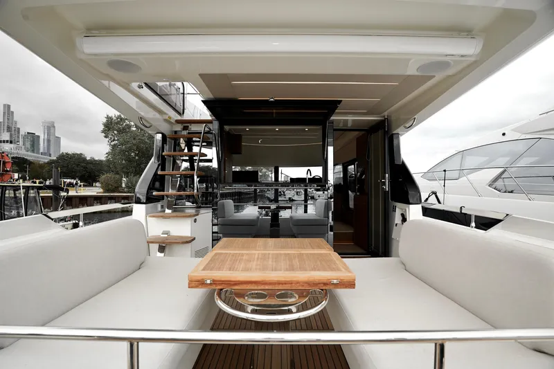  Yacht Photos Pics Luxurious 2026 Prestige F4.9 yacht interior with elegant seating and wooden table.