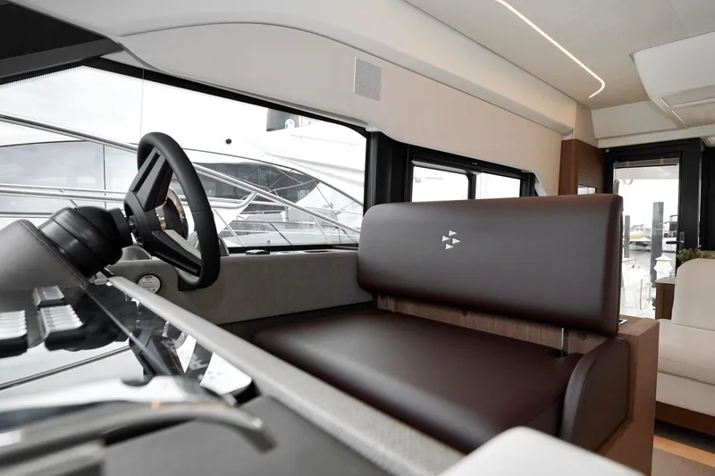  Yacht Photos Pics Interior of 2026 Prestige F4.9 yacht, featuring sleek steering and modern seating.