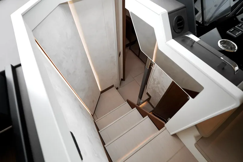  Yacht Photos Pics Modern interior staircase of Prestige F4.9 yacht, 2026 model, featuring sleek design and ambient lighting.