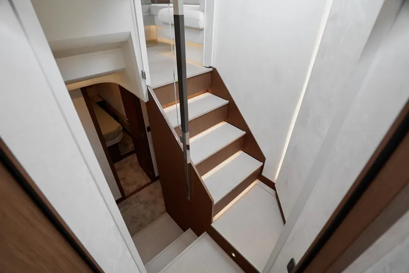  Yacht Photos Pics Modern staircase in 2026 Prestige F4.9 yacht, featuring sleek design and ambient lighting.