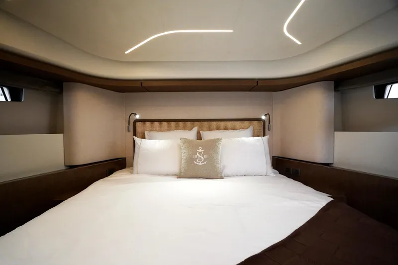  Yacht Photos Pics Luxurious cabin interior of 2026 Prestige F4.9 yacht with elegant bedding and modern lighting.