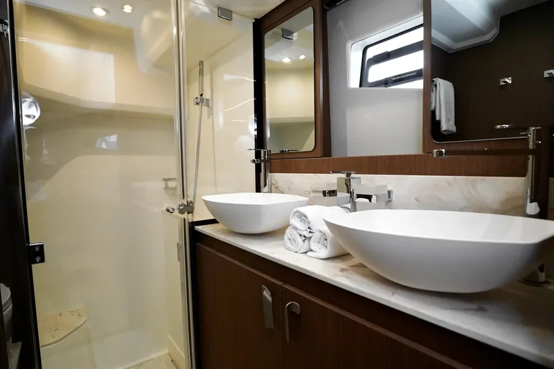  Yacht Photos Pics Luxurious bathroom in 2026 Prestige F4.9 yacht with dual sinks and modern shower.