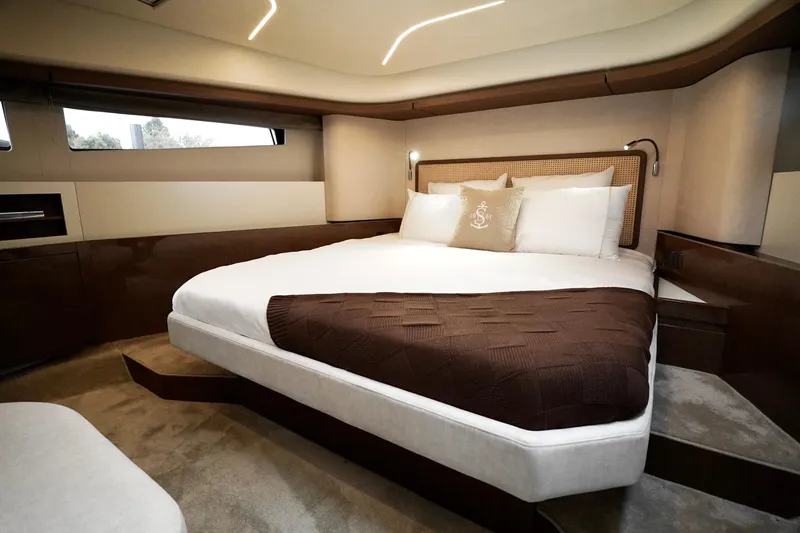  Yacht Photos Pics Luxurious bedroom interior of 2026 Prestige F4.9 yacht with elegant bedding and modern design.